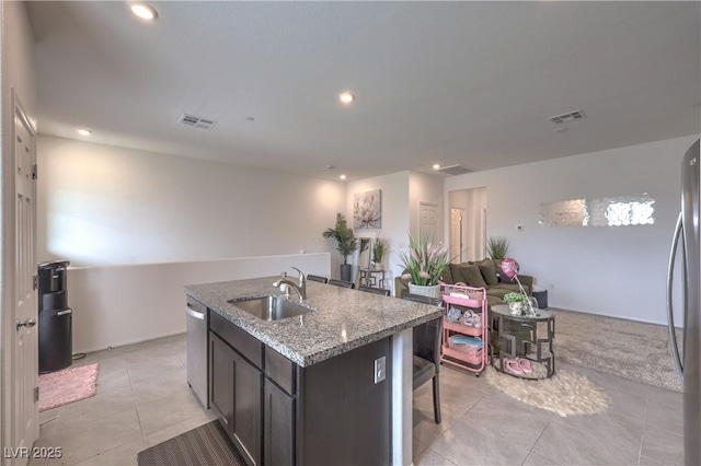 1120 Tektite Ave, Henderson, NV 89011 - kitchen featuring light tile patterned floors, stainless steel appliances, open floor plan, a kitchen island with sink, and recessed lighting