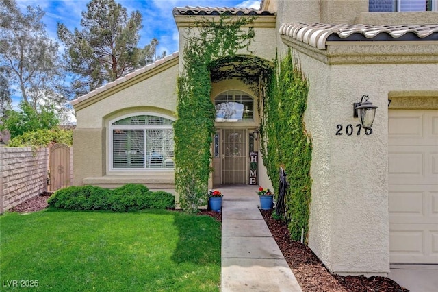 2073 Sapphire Valley Ave, Henderson, NV 89074 - property entrance featuring a garage, stucco siding, a tiled roof, and a gate