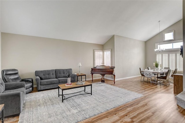 2073 Sapphire Valley Ave, Henderson, NV 89074 - living room with a chandelier, wood finished floors, and high vaulted ceiling
