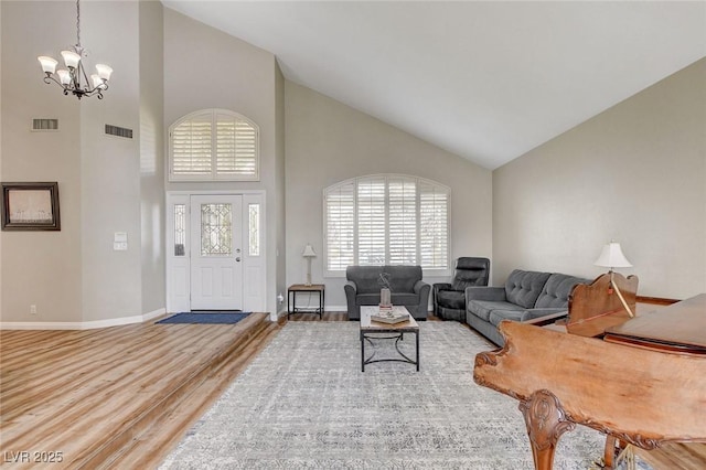 2073 Sapphire Valley Ave, Henderson, NV 89074 - living room with high vaulted ceiling, a chandelier, and wood finished floors
