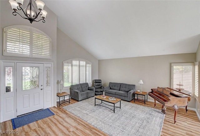 2073 Sapphire Valley Ave, Henderson, NV 89074 - living room featuring a chandelier, light wood-style flooring, and high vaulted ceiling