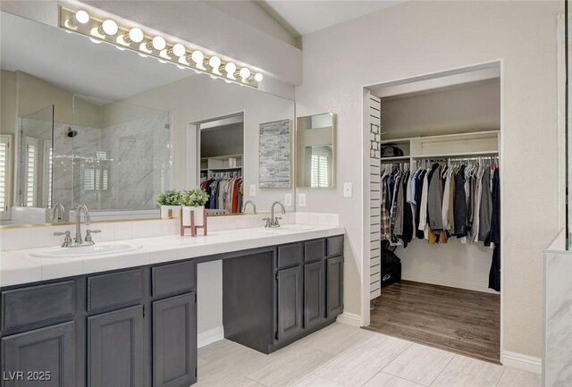 2073 Sapphire Valley Ave, Henderson, NV 89074 - bathroom featuring double vanity, a stall shower, and a spacious closet