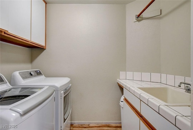 2073 Sapphire Valley Ave, Henderson, NV 89074 - laundry area with washing machine and clothes dryer, cabinet space, and light wood finished floors