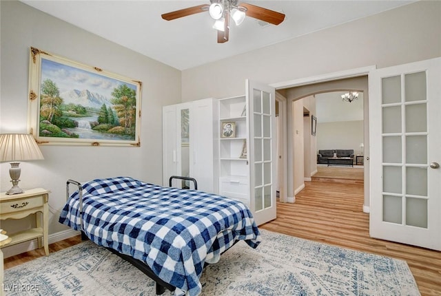 2073 Sapphire Valley Ave, Henderson, NV 89074 - bedroom with wood finished floors, arched walkways, french doors, and ceiling fan