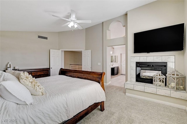 2073 Sapphire Valley Ave, Henderson, NV 89074 - bedroom with lofted ceiling, carpet flooring, a fireplace, connected bathroom, and ceiling fan
