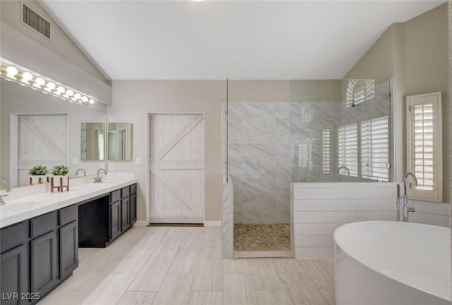 2073 Sapphire Valley Ave, Henderson, NV 89074 - full bath featuring a soaking tub, a walk in shower, double vanity, and vaulted ceiling