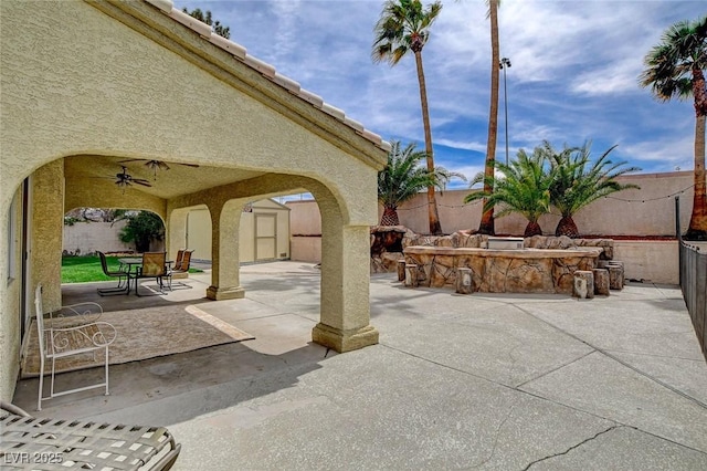 2073 Sapphire Valley Ave, Henderson, NV 89074 - fenced backyard featuring a patio, a storage shed, outdoor dining area, and a ceiling fan