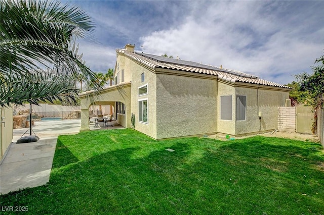 2073 Sapphire Valley Ave, Henderson, NV 89074 - back of property with stucco siding, roof mounted solar panels, a patio, and a fenced backyard