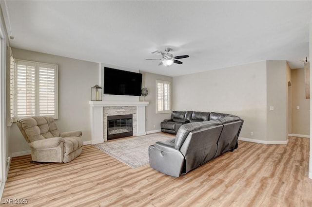 2073 Sapphire Valley Ave, Henderson, NV 89074 - living area with wood finished floors, ceiling fan, and a glass covered fireplace