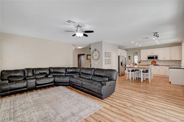 2073 Sapphire Valley Ave, Henderson, NV 89074 - living area featuring light wood-style floors, ceiling fan, and recessed lighting