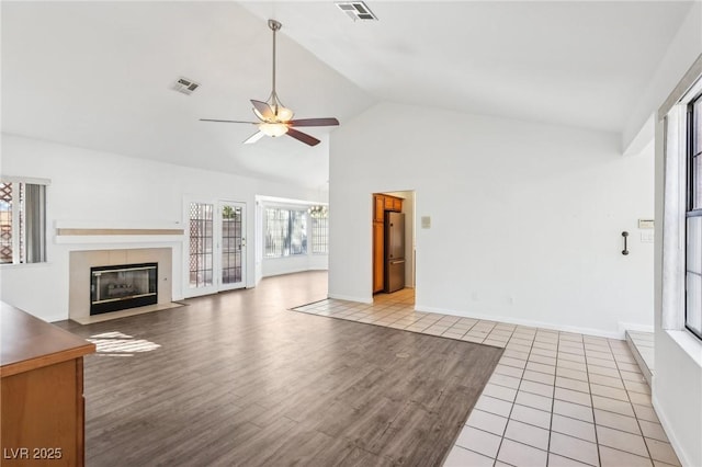 1911 Hobson Dr, Henderson, NV 89074 - unfurnished living room with ceiling fan, a fireplace, wood finished floors, and high vaulted ceiling