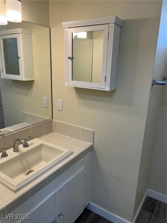 1809 Lamplighter Ln, Las Vegas, NV 89104 - bathroom with vanity, wood finished floors, and a textured wall