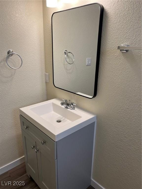 1809 Lamplighter Ln, Las Vegas, NV 89104 - bathroom with wood finished floors, vanity, and a textured wall