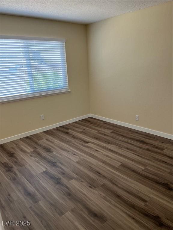 1809 Lamplighter Ln, Las Vegas, NV 89104 - spare room with a textured ceiling and dark wood finished floors