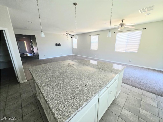 3708 Fuselier Dr, North Las Vegas, NV 89032 - kitchen featuring a ceiling fan, white cabinetry, a kitchen island, and dark tile patterned floors