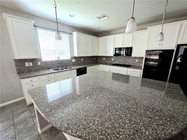 3708 Fuselier Dr, North Las Vegas, NV 89032 - kitchen with black appliances, decorative backsplash, white cabinetry, tile patterned flooring, and decorative light fixtures