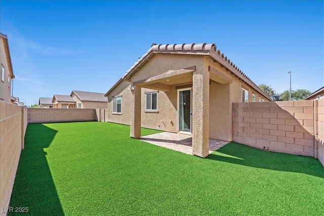 3708 Fuselier Dr, North Las Vegas, NV 89032 - rear view of house with stucco siding, a fenced backyard, and a patio