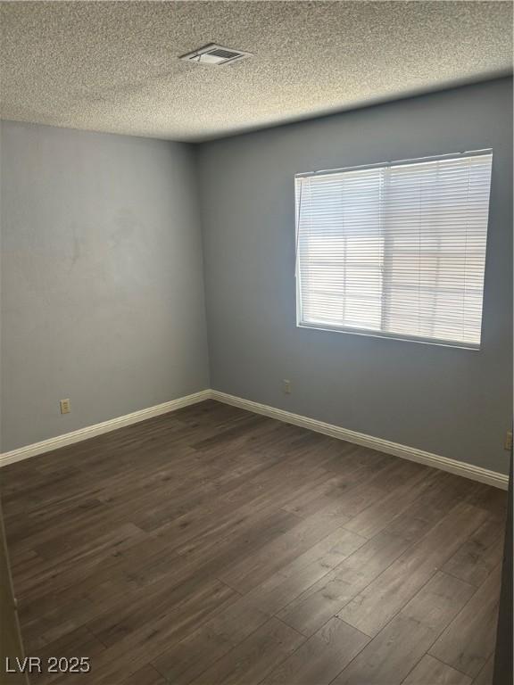 2722 Alicialynn Way, Las Vegas, NV 89121 - empty room with dark wood-style floors and a textured ceiling