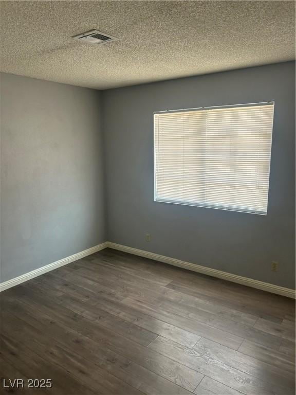 2722 Alicialynn Way, Las Vegas, NV 89121 - empty room with dark wood finished floors and a textured ceiling