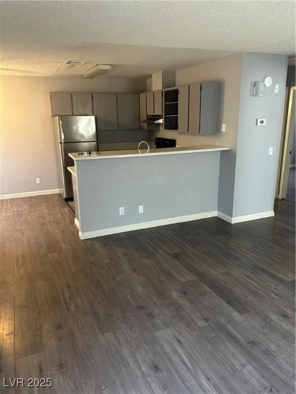 2722 Alicialynn Way, Las Vegas, NV 89121 - kitchen with gray cabinets, freestanding refrigerator, a textured ceiling, light countertops, and a peninsula