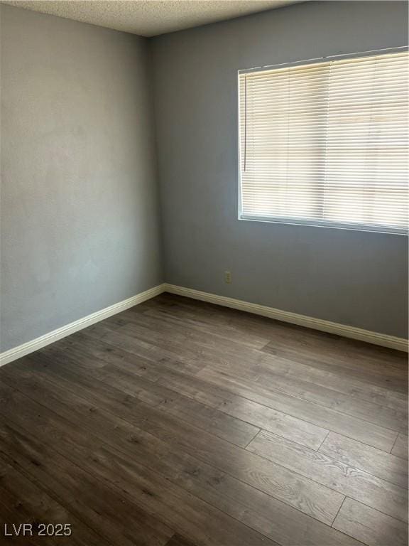 2722 Alicialynn Way, Las Vegas, NV 89121 - empty room featuring dark wood-style flooring and baseboards