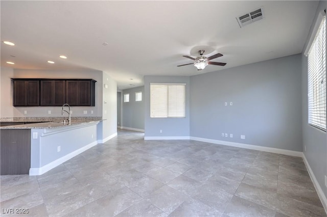2300 Sky Island Dr, Henderson, NV 89002 - kitchen featuring a ceiling fan, dark brown cabinetry, healthy amount of natural light, recessed lighting, and open floor plan