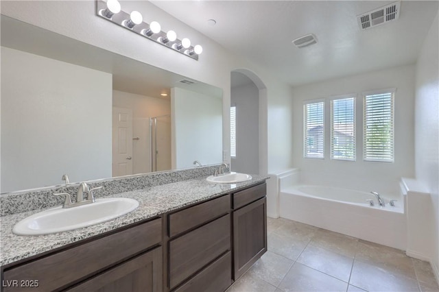 2300 Sky Island Dr, Henderson, NV 89002 - full bathroom featuring a bath, double vanity, tile patterned flooring, and a shower stall