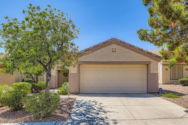 2085 Joy View Ln, Henderson, NV 89012 - view of front of home with stucco siding, concrete driveway, and a garage
