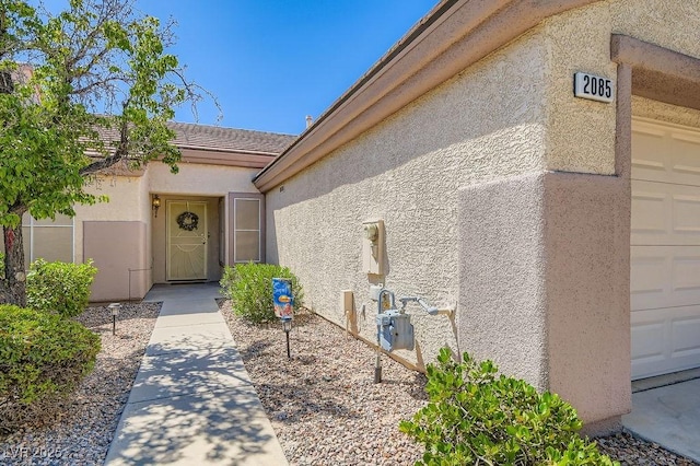 2085 Joy View Ln, Henderson, NV 89012 - view of exterior entry with stucco siding and a tile roof