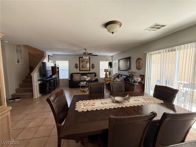 8898 Promised Land Ave, Las Vegas, NV 89148 - dining room with ceiling fan, light tile patterned floors, and stairs