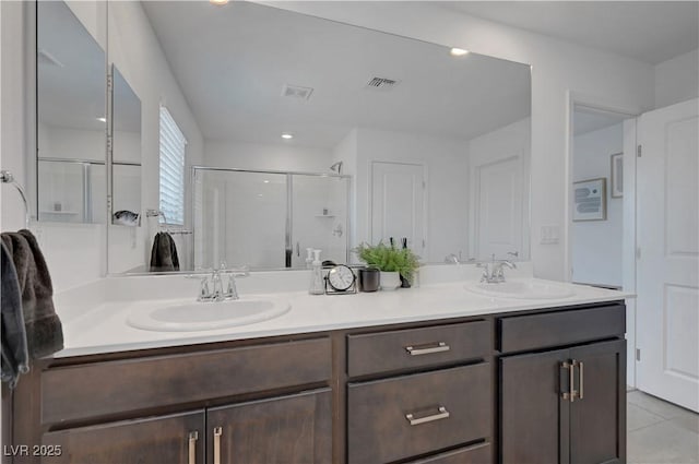 7853 Bethel Heights Ln, Las Vegas, NV 89113 - full bath featuring double vanity, a stall shower, and tile patterned flooring