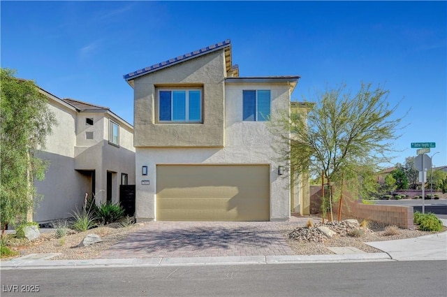 7853 Bethel Heights Ln, Las Vegas, NV 89113 - view of front of property with stucco siding, an attached garage, and decorative driveway