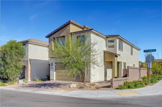 7853 Bethel Heights Ln, Las Vegas, NV 89113 - view of front facade with stucco siding, a garage, and driveway