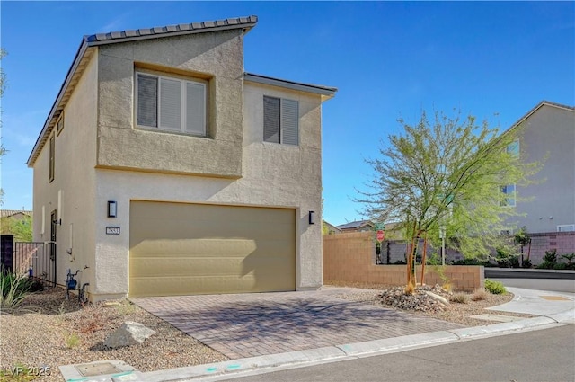 7853 Bethel Heights Ln, Las Vegas, NV 89113 - view of front of house with an attached garage, stucco siding, and decorative driveway