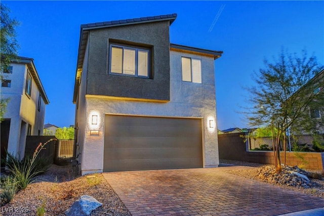 7853 Bethel Heights Ln, Las Vegas, NV 89113 - contemporary house featuring an attached garage, stucco siding, and decorative driveway
