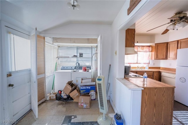 1213 New Mexico St, Boulder City, NV 89005 - kitchen featuring freestanding refrigerator, washing machine and clothes dryer, brown cabinets, ventilation hood, and ceiling fan