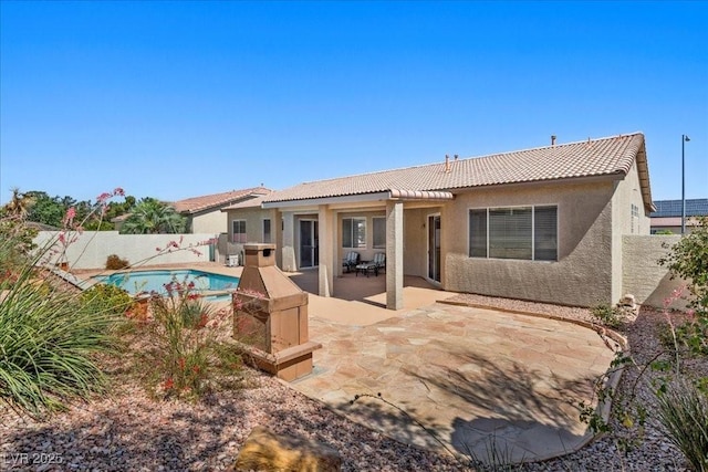 745 Diamond Bend Ave, Las Vegas, NV 89123 - rear view of property featuring a tile roof, stucco siding, a fenced backyard, and a patio area