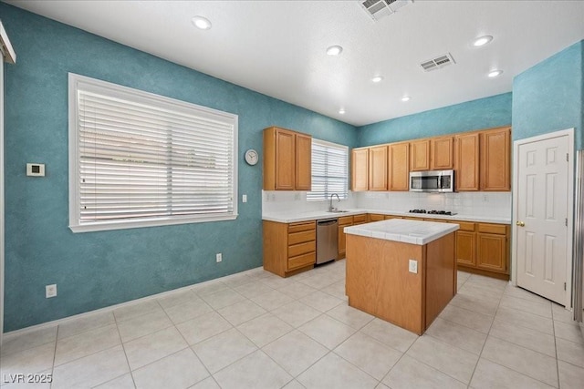 745 Diamond Bend Ave, Las Vegas, NV 89123 - kitchen featuring stainless steel appliances, a kitchen island, tasteful backsplash, tile countertops, and recessed lighting