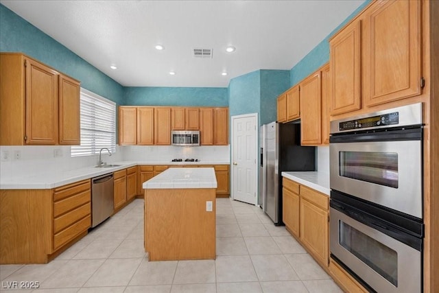 745 Diamond Bend Ave, Las Vegas, NV 89123 - kitchen featuring stainless steel appliances, a center island, tile countertops, light tile patterned floors, and recessed lighting