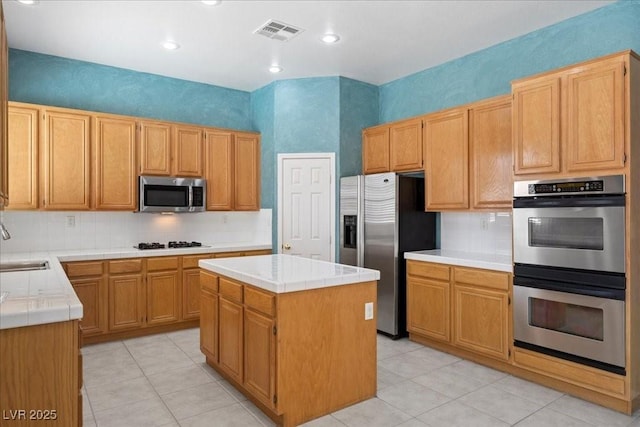 745 Diamond Bend Ave, Las Vegas, NV 89123 - kitchen featuring appliances with stainless steel finishes, tile counters, light tile patterned floors, backsplash, and recessed lighting