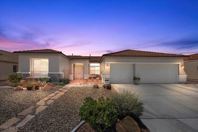 745 Diamond Bend Ave, Las Vegas, NV 89123 - view of front facade with a garage, driveway, stucco siding, stone siding, and a tile roof