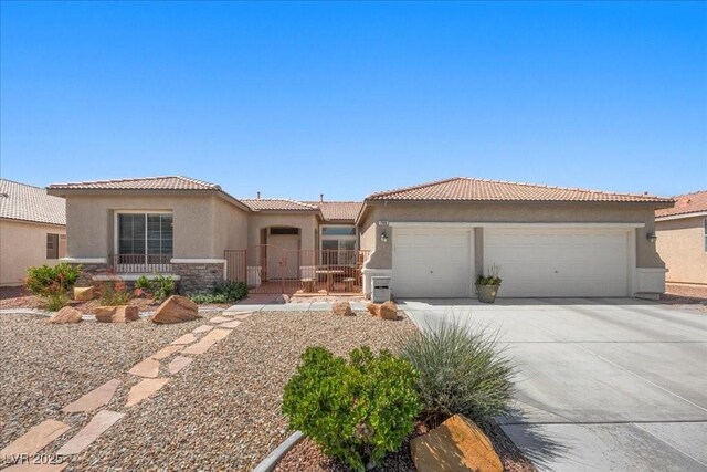745 Diamond Bend Ave, Las Vegas, NV 89123 - view of front of property featuring a garage, stucco siding, concrete driveway, a tiled roof, and stone siding