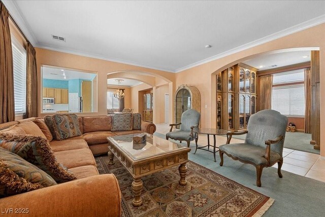 745 Diamond Bend Ave, Las Vegas, NV 89123 - living area featuring arched walkways, healthy amount of natural light, light colored carpet, crown molding, and light tile patterned floors