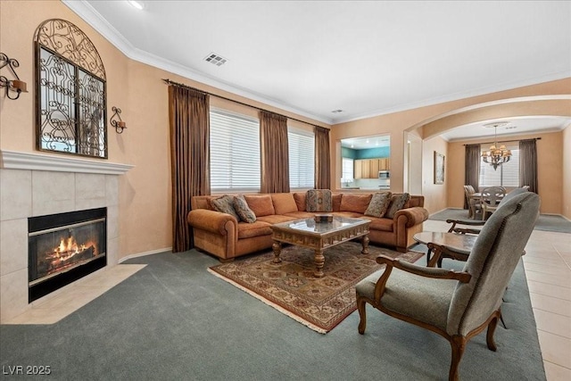 745 Diamond Bend Ave, Las Vegas, NV 89123 - living area with crown molding, a chandelier, a tiled fireplace, and arched walkways