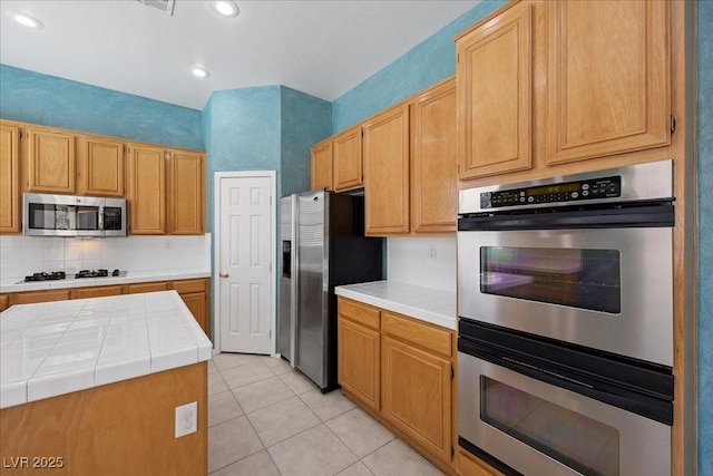 745 Diamond Bend Ave, Las Vegas, NV 89123 - kitchen featuring stainless steel appliances, tile countertops, light tile patterned floors, tasteful backsplash, and recessed lighting