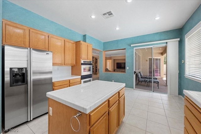 745 Diamond Bend Ave, Las Vegas, NV 89123 - kitchen featuring stainless steel appliances, tile countertops, a center island, recessed lighting, and light tile patterned flooring