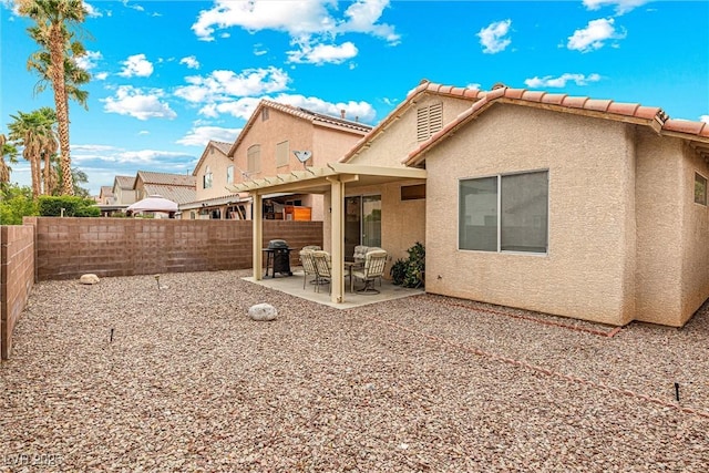 8853 Kingswood Dr, Las Vegas, NV 89147 - back of house featuring a patio, stucco siding, a fenced backyard, and a tile roof