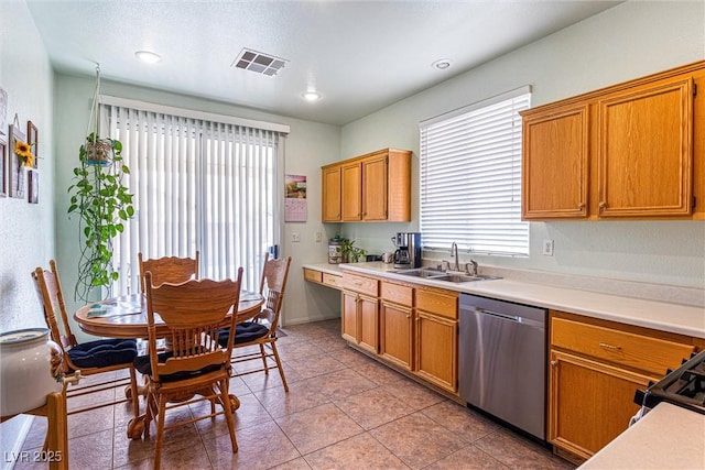 8853 Kingswood Dr, Las Vegas, NV 89147 - kitchen with dishwasher, light countertops, light tile patterned floors, and brown cabinets