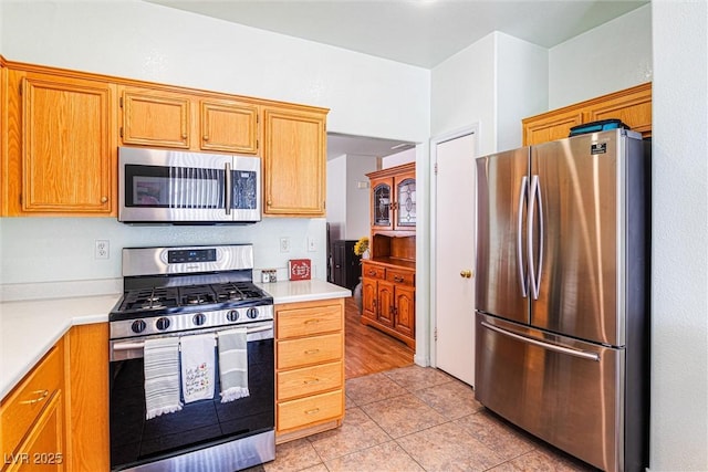 8853 Kingswood Dr, Las Vegas, NV 89147 - kitchen with stainless steel appliances, light countertops, and light tile patterned floors