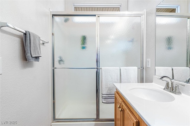 8853 Kingswood Dr, Las Vegas, NV 89147 - bathroom featuring vanity, a shower stall, and a textured wall